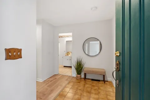 a bedroom with a bed and a potted plant