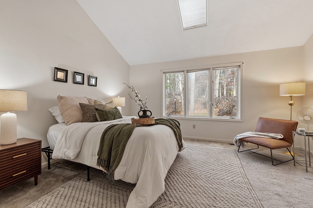28 Monadnock Drive, Unit 28 Westford, MA 01886 - Photo 13 of 31 a spacious bedroom with a bed and a couch