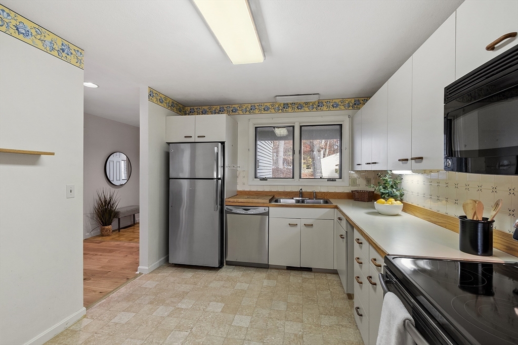 28 Monadnock Drive, Unit 28 Westford, MA 01886 - Photo 15 of 31 a kitchen with a sink appliances and cabinets