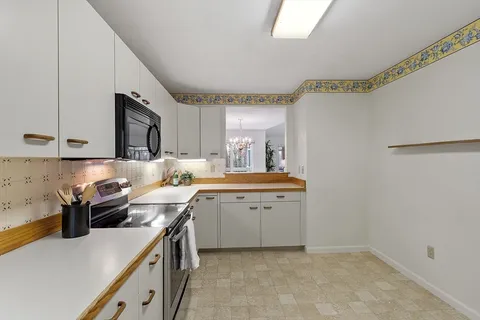 a kitchen with a sink and a stove top oven