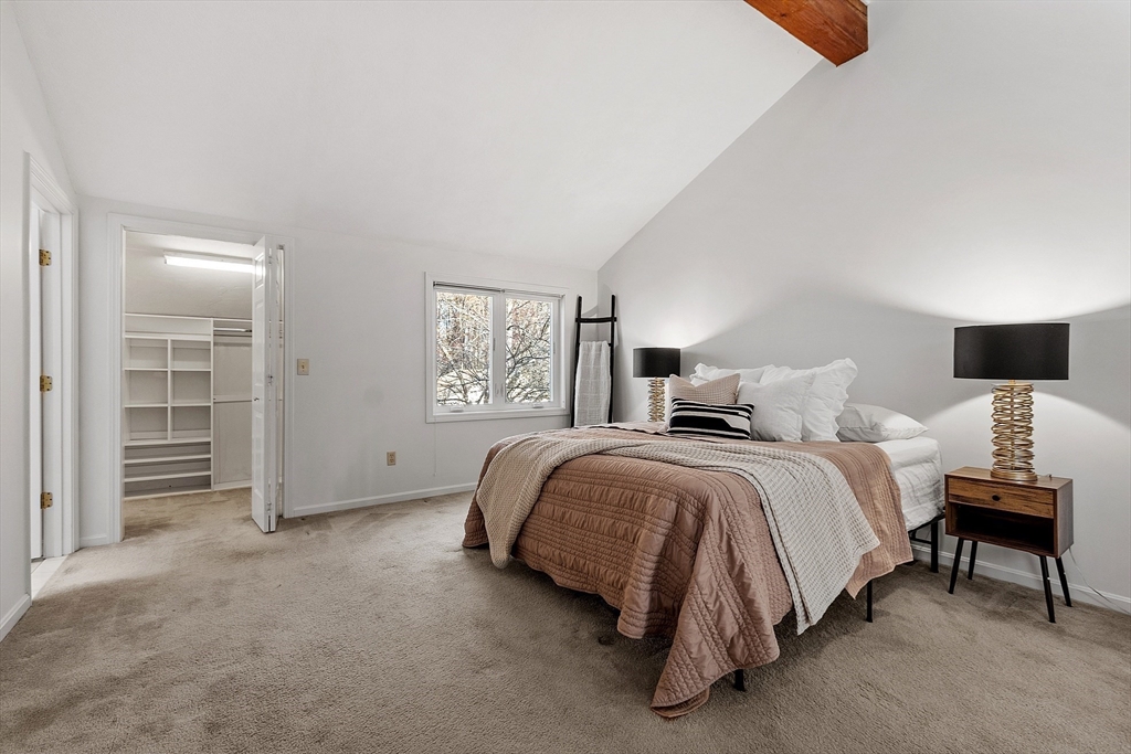 28 Monadnock Drive, Unit 28 Westford, MA 01886 - Photo 17 of 31 a spacious bedroom with a bed and a lamp