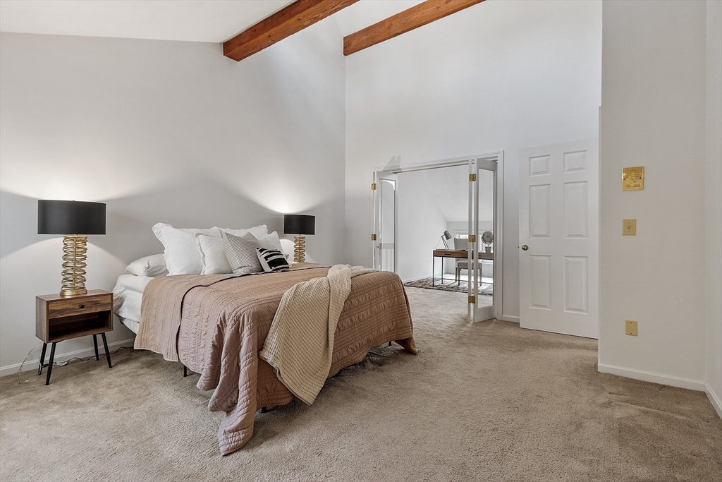 28 Monadnock Drive, Unit 28 Westford, MA 01886 - Photo 18 of 31 a spacious bedroom with a bed and a lamp