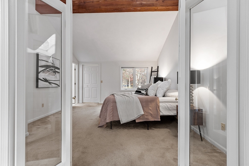 28 Monadnock Drive, Unit 28 Westford, MA 01886 - Photo 19 of 31 a bed room with a bed and a mirror