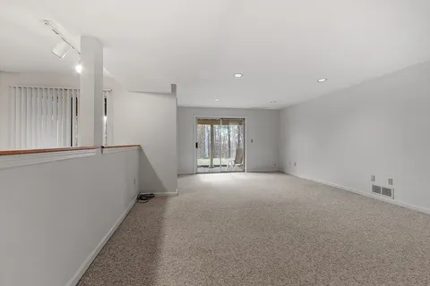 a front view of a building with a garden