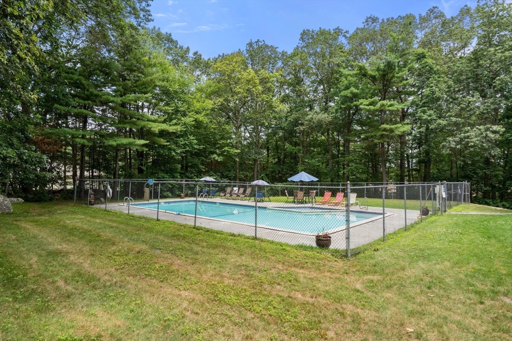 28 Monadnock Drive, Unit 28 Westford, MA 01886 - Photo 30 of 31 a view of a backyard with trampoline