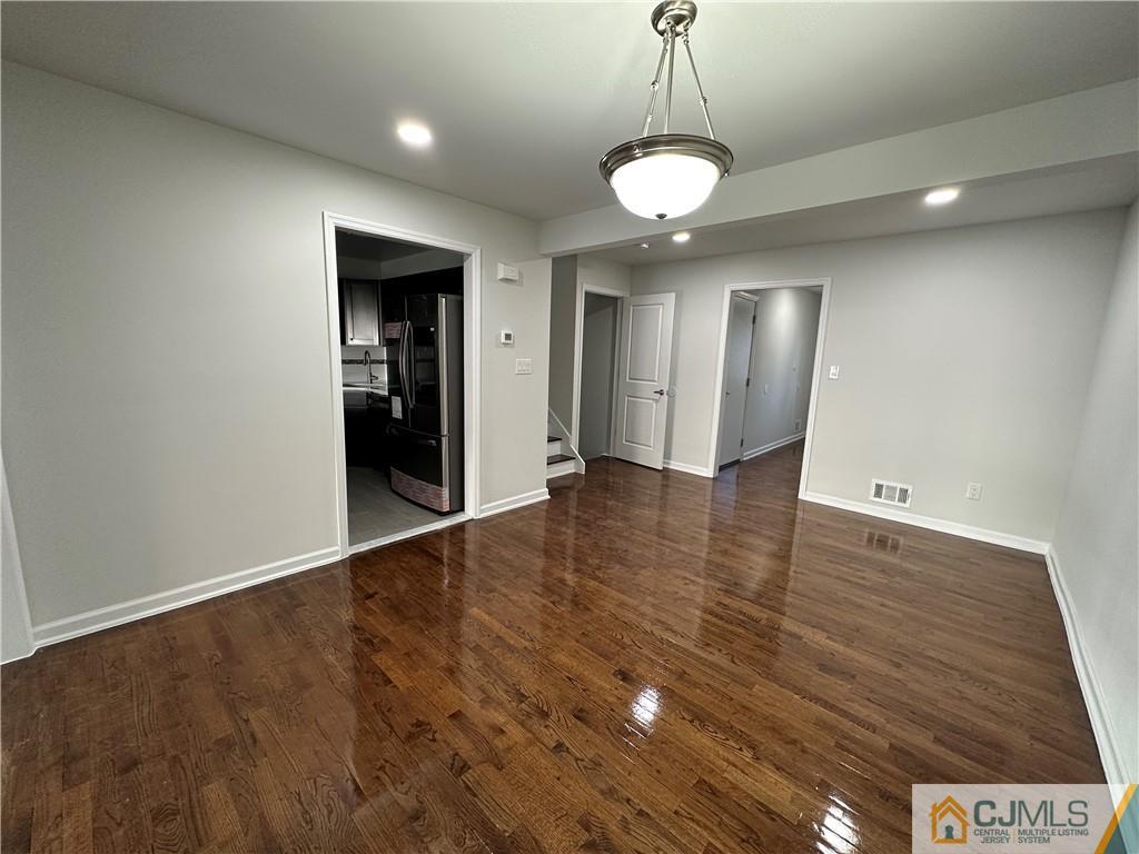 3703 Hana Road Edison, NJ 08817 - Photo 8 of 55 an empty room with wooden floor and windows