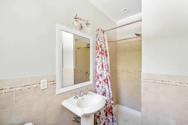 a bathroom with a sink mirror and a shower