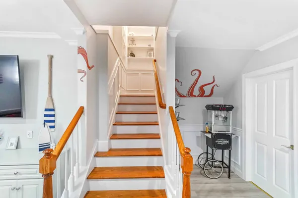 a view of entryway with wooden floor and stairs