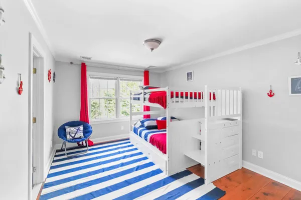 a bedroom with furniture and a window