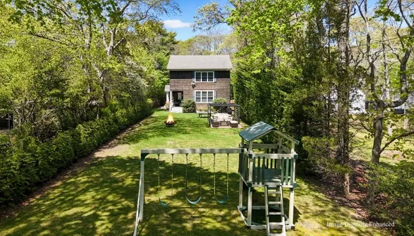 a balcony with table and chairs and potted plants