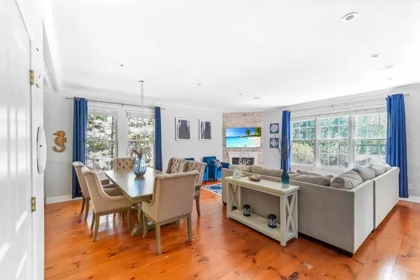 a view of a dining room with furniture window and wooden floor