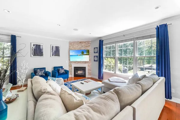 a living room with furniture large window and a fireplace