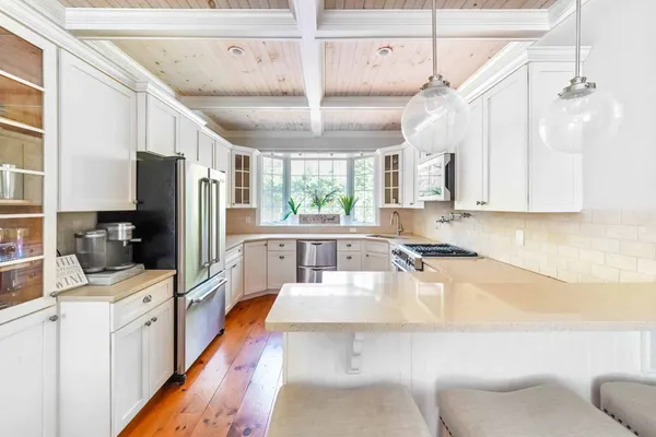 a large kitchen with a large window appliances and cabinets