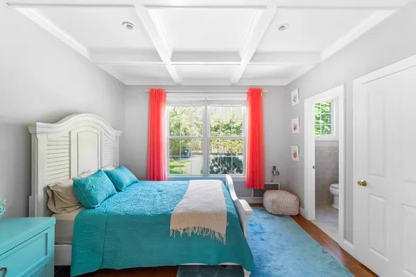 a bed room with a bed and a large window