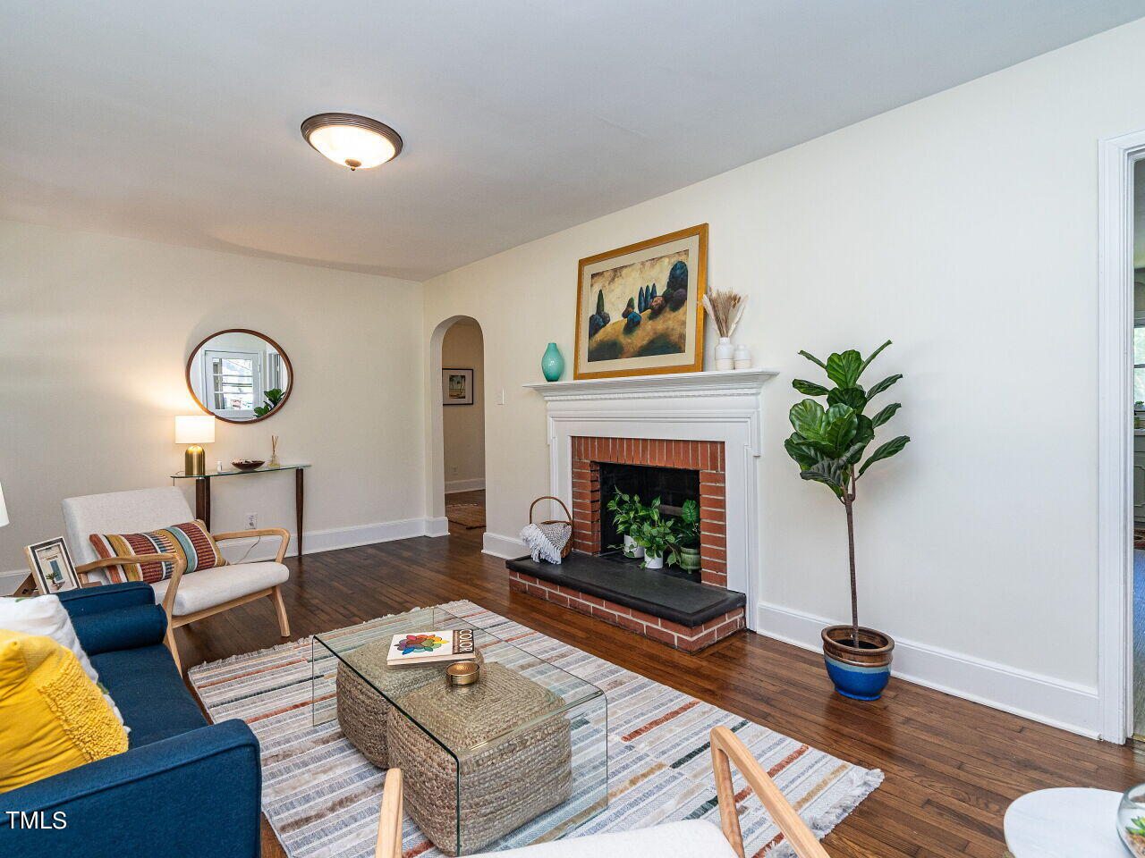 1112 Horton Road Durham, NC 27704 - Photo 7 of 30 a living room with furniture and a fireplace