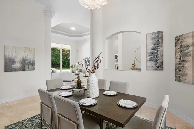 a view of a dining room with furniture and chandelier