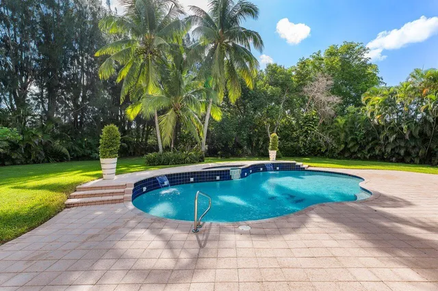 a view of pool with yard