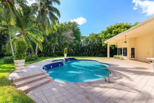 a view of a swimming pool with a yard