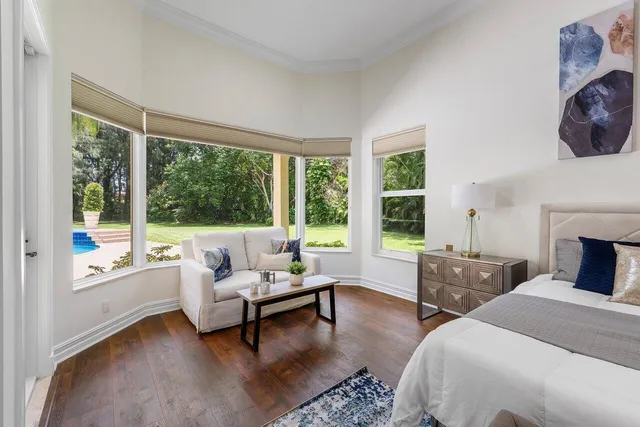 a bedroom with furniture and a large window