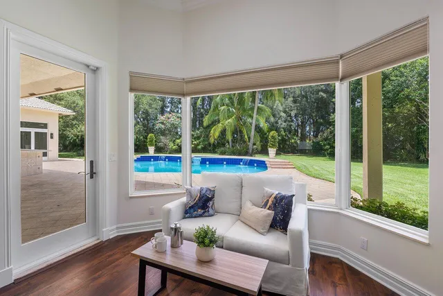 a living room with furniture and a floor to ceiling window