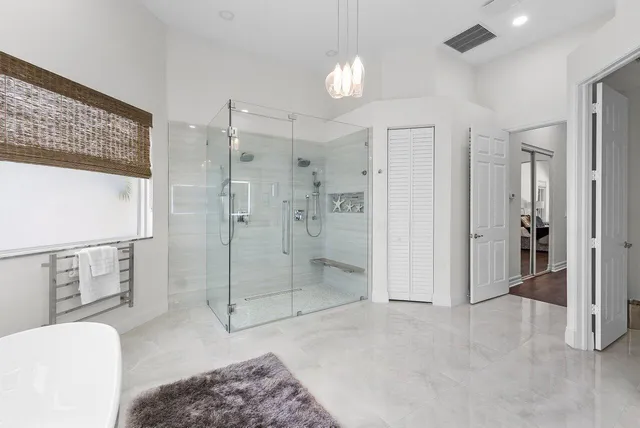 a spacious bathroom with a shower and a sink