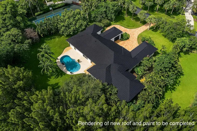 an aerial view of a house with a yard and garden