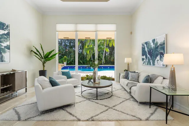 a living room with furniture a table and a potted plant
