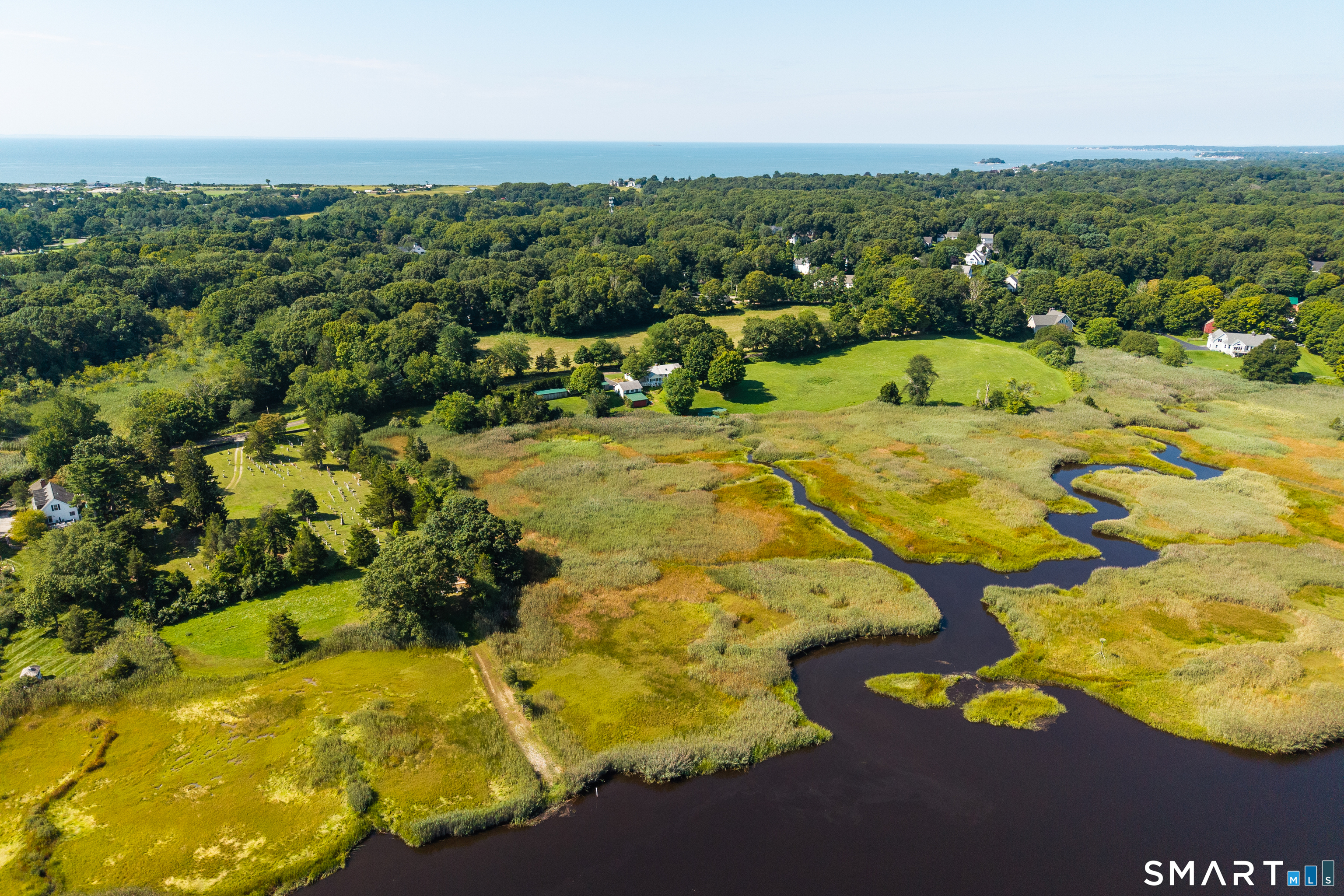 118 River Road Madison, CT 06443 - Photo 2 of 25 This view is from the Hammonassett River looking towards the home. Take note of a branch of the river that connects to a dock at the house rear.