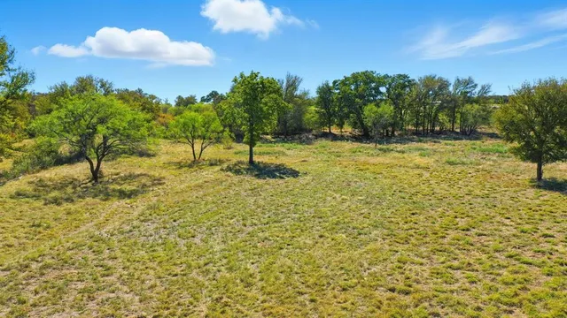 a swimming pool with trees in the background