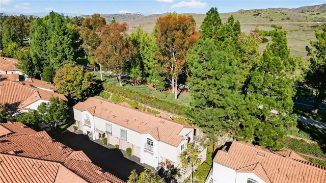 an aerial view of a house with a yard