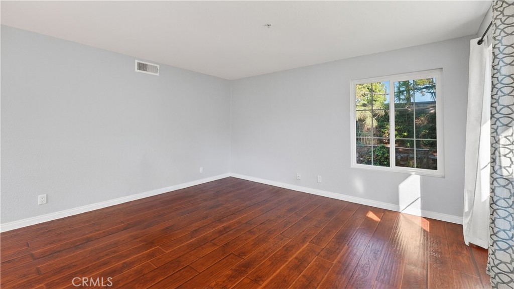 103 South Cross Creek Road, Unit B Orange, CA 92869 - Photo 5 of 29 a view of empty room with wooden floor and fan