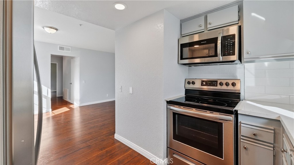 103 South Cross Creek Road, Unit B Orange, CA 92869 - Photo 7 of 29 a kitchen with a stove and a microwave