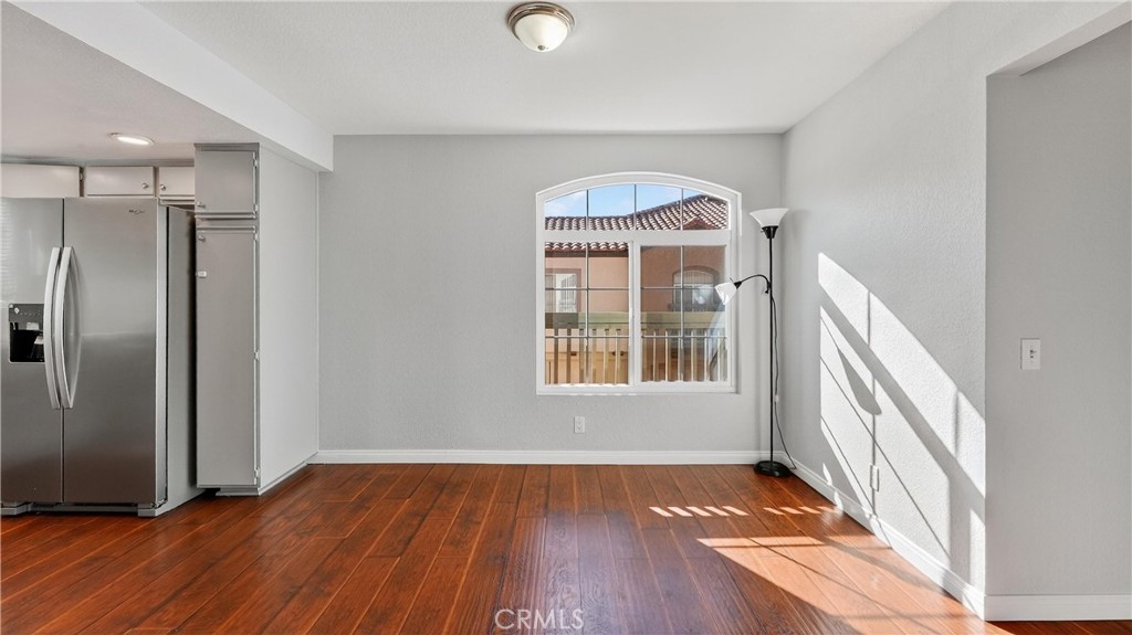 103 South Cross Creek Road, Unit B Orange, CA 92869 - Photo 9 of 29 a view of an empty room with wooden floor and a window