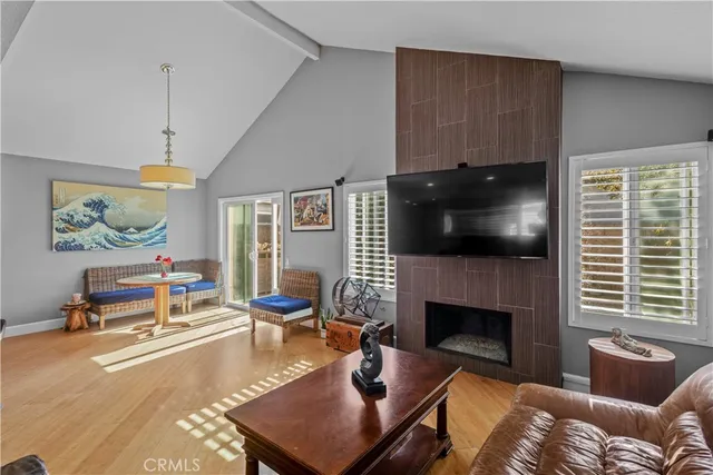 a living room with furniture pool table and a flat screen tv