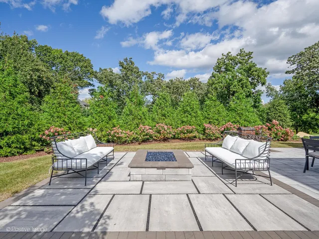 a living room with fireplace furniture and a large window