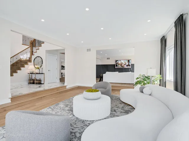 a kitchen with stainless steel appliances kitchen island granite countertop a table chairs sink and cabinets