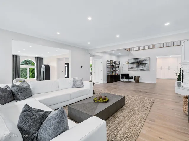 a kitchen with stainless steel appliances a dining table and chairs