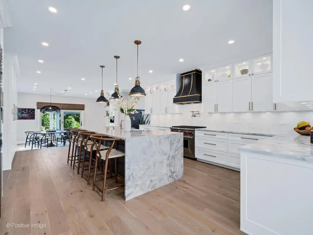 a spacious bedroom with a bed and a chandelier