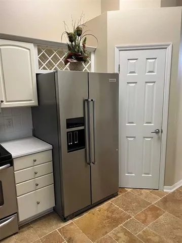 a stove top oven sitting inside of a kitchen