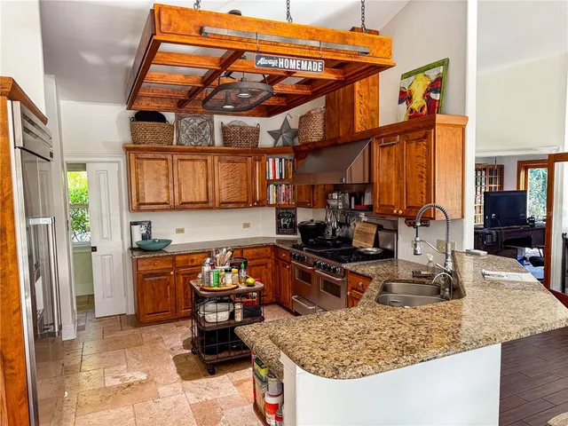 a kitchen with stainless steel appliances granite countertop a sink stove and refrigerator