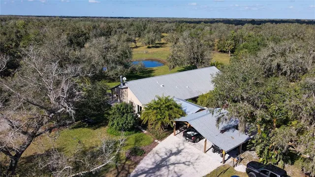 an aerial view of a house with a yard