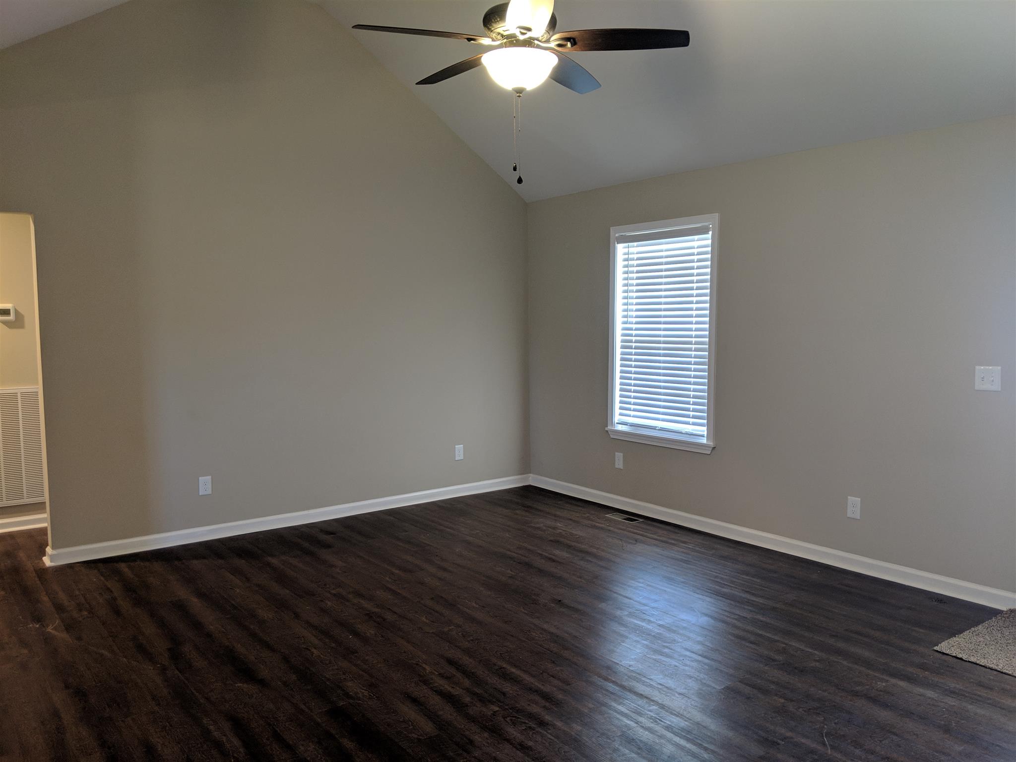 147 A T G T Road Portland, TN 37148 - Photo 3 of 11 a view of an empty room with wooden floor and a window