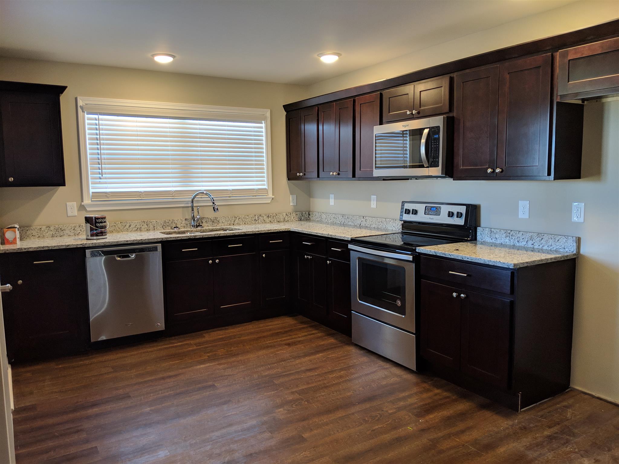 147 A T G T Road Portland, TN 37148 - Photo 5 of 11 a kitchen with stainless steel appliances granite countertop a sink a stove top oven and wooden floors