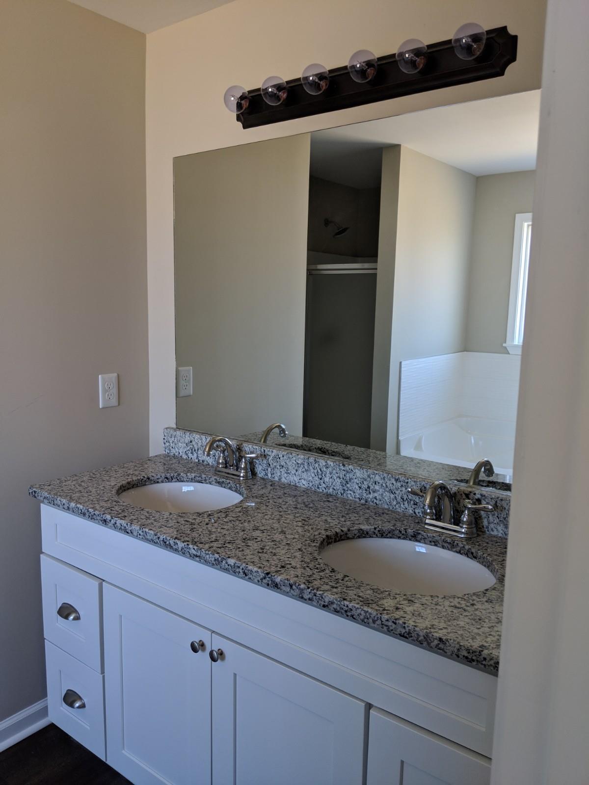 147 A T G T Road Portland, TN 37148 - Photo 7 of 11 a bathroom with a granite countertop sink and a mirror