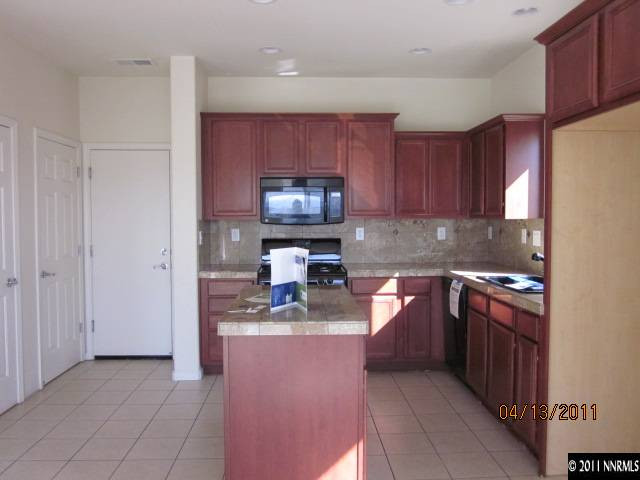 1436 Hagar Road Reno, NV 89506 - Photo 4 of 10 a kitchen with stainless steel appliances granite countertop a stove a sink and a microwave