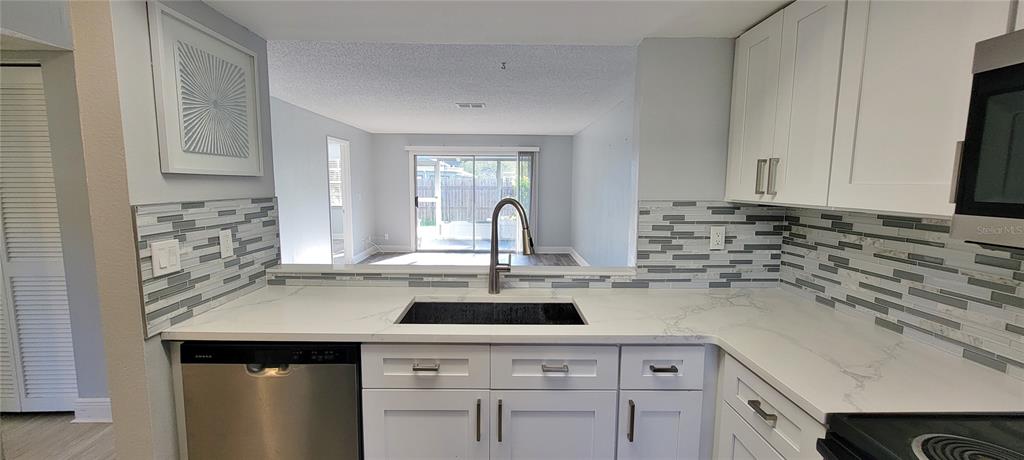 3342 Teeside Drive New Port Richey, FL 34655 - Photo 12 of 45 a kitchen with a sink cabinets and window
