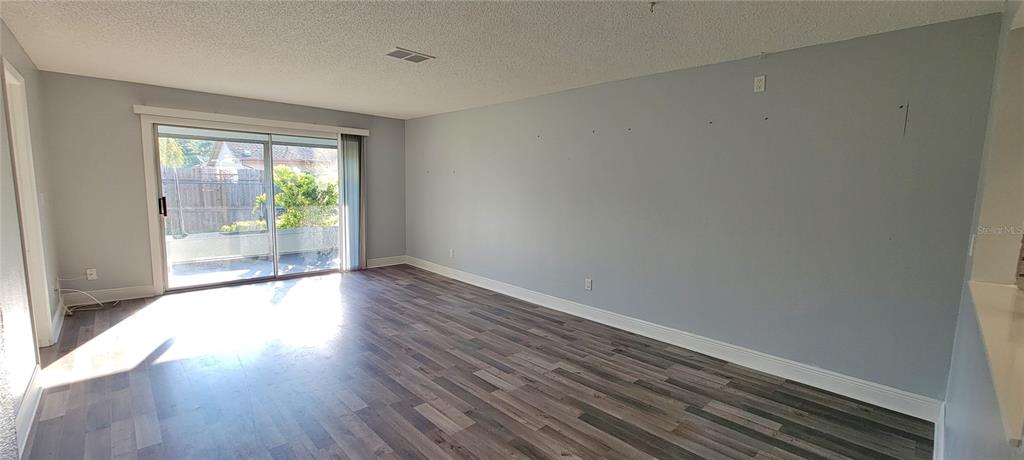 3342 Teeside Drive New Port Richey, FL 34655 - Photo 13 of 45 a view of an empty room with wooden floor and a window