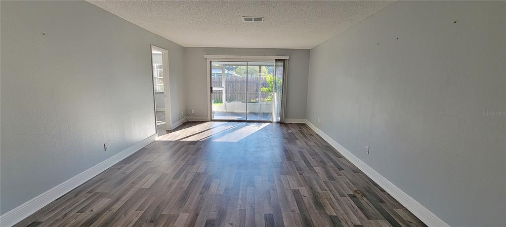 3342 Teeside Drive New Port Richey, FL 34655 - Photo 14 of 45 a view of an empty room with wooden floor and a window