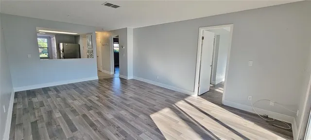 a view of a room with wooden floor and staircase