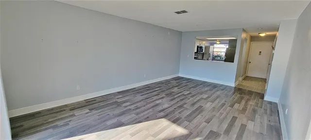 a view of wooden floor and windows in a room